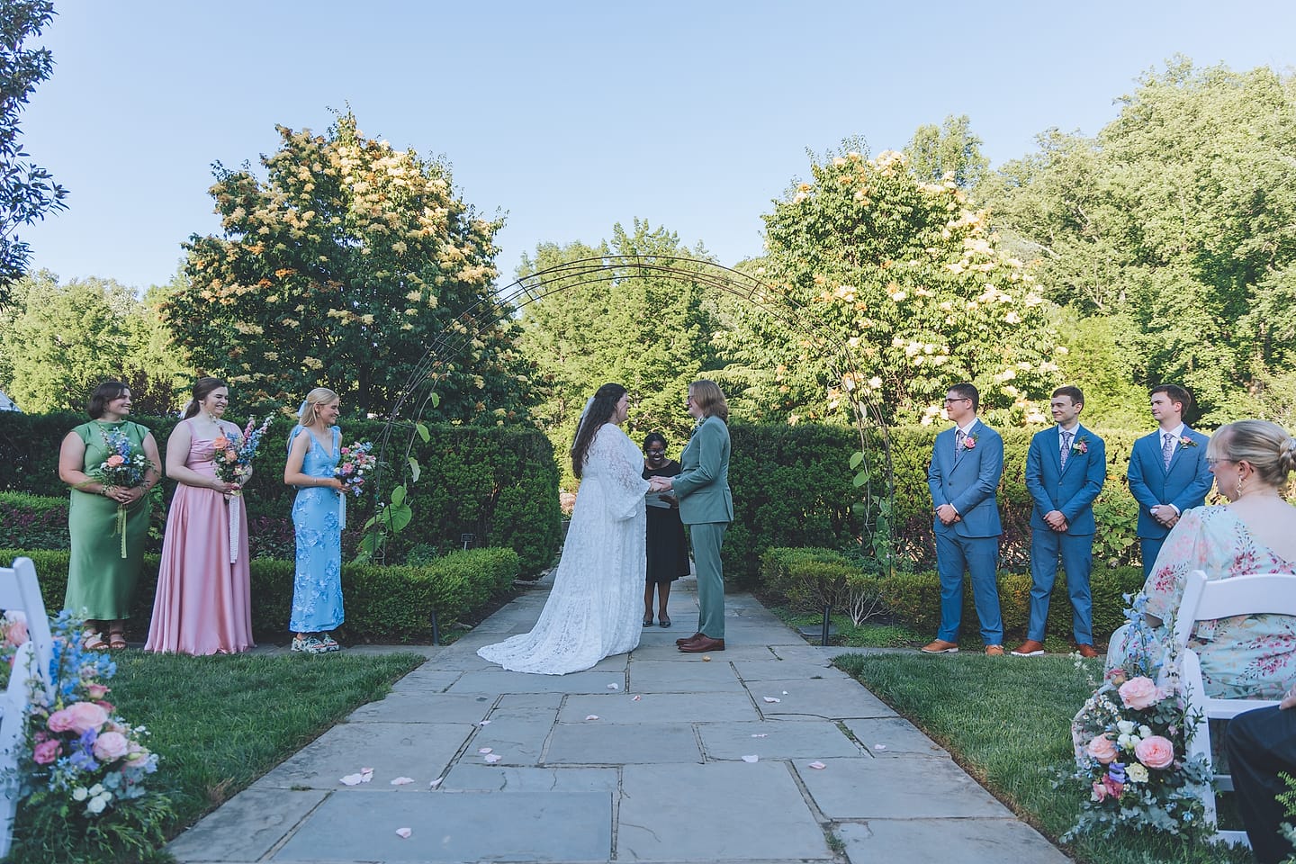 Outdoor garden wedding ceremony with a pastel wedding party at Brookside Gardens in the DMV