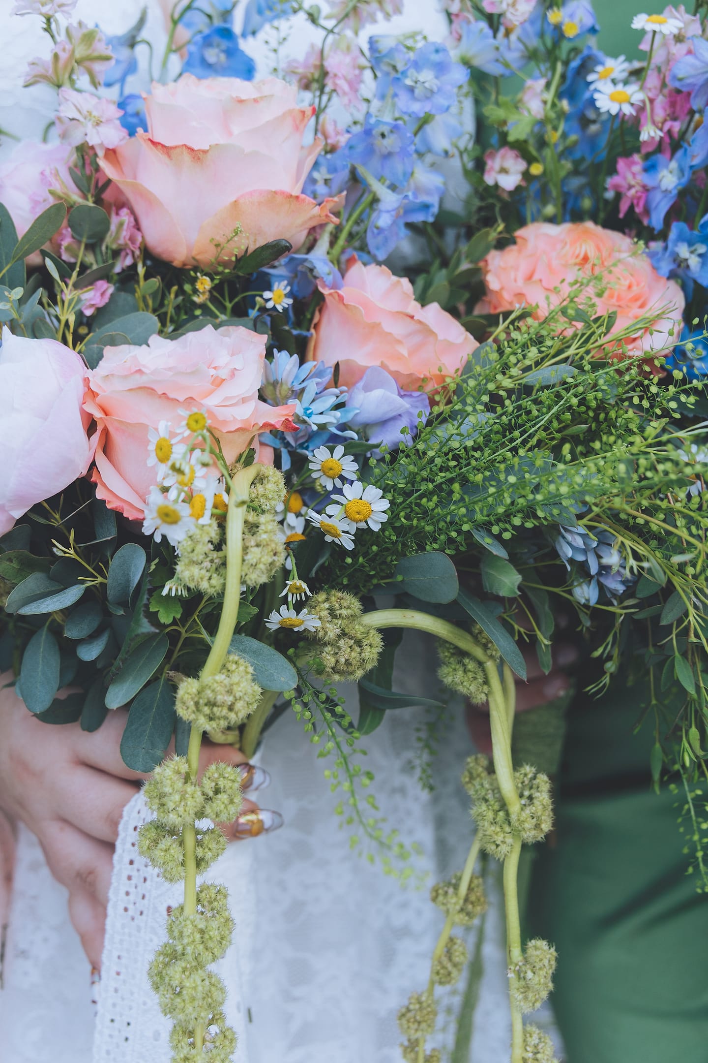 Detail of a peach rose, delphinium, and daisy bridal bouquet at a DMV garden wedding