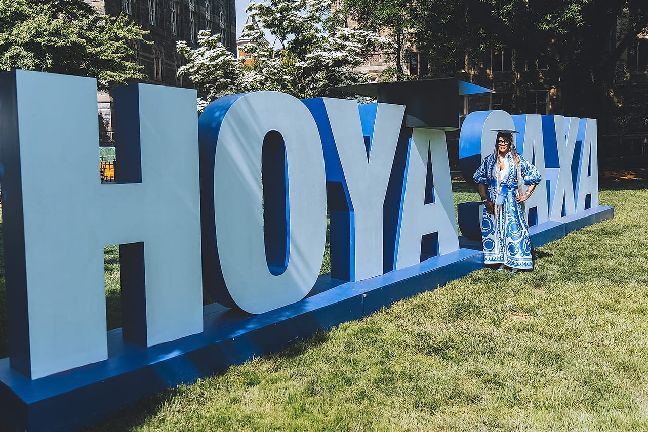 Graduate celebrating in academic regalia