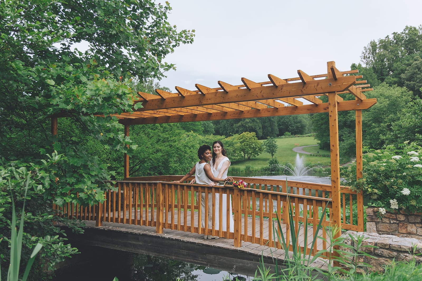 Two brides kissing after their outdoor wedding ceremony